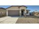 Inviting single-Gathering home boasting a two-car garage and desert landscaping at 15065 W Hackamore Dr, Surprise, AZ 85387