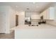 Bright kitchen featuring stainless steel appliances, white cabinets, and quartz countertops at 15065 W Hackamore Dr, Surprise, AZ 85387