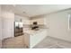 Bright, all-white kitchen with stainless appliances, quartz countertops, and tile flooring at 15065 W Hackamore Dr, Surprise, AZ 85387