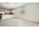 Spacious living area flowing into a modern kitchen with stainless steel appliances at 15065 W Hackamore Dr, Surprise, AZ 85387