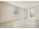 Living area offering tile floors, natural light, and sliding doors to the patio at 15065 W Hackamore Dr, Surprise, AZ 85387