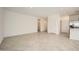 Open living space with neutral tile flooring and seamless flow to the kitchen area at 15065 W Hackamore Dr, Surprise, AZ 85387