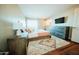 Bedroom with a large bed, soft rug, dresser, and flat screen television at 1645 W Baseline Rd # 2026, Mesa, AZ 85202
