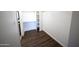 A spacious walk-in closet with white walls and shelving, as well as wood-look flooring at 1645 W Baseline Rd # 2026, Mesa, AZ 85202