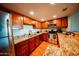 Charming kitchen with stainless steel appliances, granite countertops, and wood cabinets at 1645 W Baseline Rd # 2026, Mesa, AZ 85202
