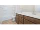 A functional bathroom featuring a double vanity, a bathtub-shower combo, and natural wood-look flooring at 1892 E Empeltre Rd, San Tan Valley, AZ 85140