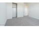 A bright bedroom featuring sliding closet doors and freshly painted white walls for a contemporary aesthetic at 1892 E Empeltre Rd, San Tan Valley, AZ 85140