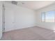 Serene bedroom bathed in natural light, complete with a plush carpet and minimalist design at 1892 E Empeltre Rd, San Tan Valley, AZ 85140