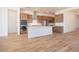Open kitchen featuring wood tile flooring, stainless steel appliances, and a center island at 1892 E Empeltre Rd, San Tan Valley, AZ 85140