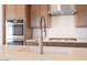 Close-up of kitchen island with stainless steel faucet, undermount sink and quartz countertop at 1892 E Empeltre Rd, San Tan Valley, AZ 85140