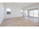 Spacious living room featuring hardwood-style flooring and sliding glass doors at 1892 E Empeltre Rd, San Tan Valley, AZ 85140