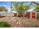 Landscaped backyard featuring gravel paths, a storage shed, and established greenery at 1910 W Holly St, Phoenix, AZ 85009