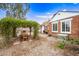 Charming backyard with brick accents, lush landscaping, and shaded outdoor dining at 1910 W Holly St, Phoenix, AZ 85009