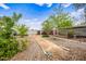 Expansive backyard featuring gravel paths, bocce ball court, and mature greenery at 1910 W Holly St, Phoenix, AZ 85009