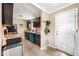 Functional kitchen with dark cabinetry, granite countertops, and modern appliances including a washer and dryer at 1910 W Holly St, Phoenix, AZ 85009