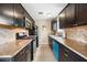 Efficient kitchen space with dark cabinets, stone countertops, and modern appliances at 1910 W Holly St, Phoenix, AZ 85009