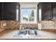 Charming kitchen sink features stainless steel fixtures and a bright window view at 1910 W Holly St, Phoenix, AZ 85009