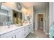 Bright bathroom featuring double sinks, white cabinets, and ample counter space at 19672 N 260Th Ave, Buckeye, AZ 85396