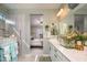 Bathroom showcasing double vanity with white cabinets and a seamless glass shower at 19672 N 260Th Ave, Buckeye, AZ 85396