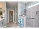 Bathroom featuring sleek, glass-enclosed shower and double sinks with ample lighting at 19672 N 260Th Ave, Buckeye, AZ 85396