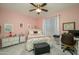 Cozy bedroom with a ceiling fan, soft lighting, and calming pink color scheme at 19672 N 260Th Ave, Buckeye, AZ 85396