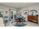 Cozy dining area with a round table, four chairs, and natural light from the patio doors at 19672 N 260Th Ave, Buckeye, AZ 85396