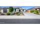 Single-story home with well-maintained landscaping and a concrete driveway in a sunny neighborhood at 19672 N 260Th Ave, Buckeye, AZ 85396