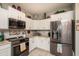 Modern kitchen featuring stainless steel appliances, white cabinets and light countertops at 19672 N 260Th Ave, Buckeye, AZ 85396