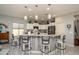 Bright kitchen featuring a breakfast bar with pendant lighting and white cabinets at 19672 N 260Th Ave, Buckeye, AZ 85396
