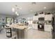 Modern kitchen featuring a large island with seating, stainless steel appliances, and pendant lighting at 19672 N 260Th Ave, Buckeye, AZ 85396