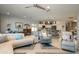 Open-concept living area with tile flooring, comfortable seating, and a view of the kitchen at 19672 N 260Th Ave, Buckeye, AZ 85396