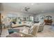 Bright living room featuring tile floors, white sofa, and recessed lighting at 19672 N 260Th Ave, Buckeye, AZ 85396