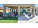Spacious patio features multiple seating areas, perfect for entertaining or relaxing outdoors, with a view of the lawn at 19672 N 260Th Ave, Buckeye, AZ 85396