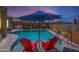 Relaxing pool area with lounge chairs and umbrella for shade at 19672 N 260Th Ave, Buckeye, AZ 85396