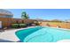 Relaxing pool area with well-maintained landscaping and decorative art on the surrounding walls at 19672 N 260Th Ave, Buckeye, AZ 85396