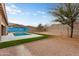 A private backyard with a sparkling pool, unique mural and low-maintenance landscaping at 23800 N 169Th Ave, Surprise, AZ 85387