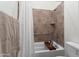 This bathroom showcases a tiled shower over tub with handrails, providing accessibility and comfort at 23800 N 169Th Ave, Surprise, AZ 85387