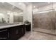 This bathroom boasts a spacious walk-in shower, granite countertop, and dual vanity, offering modern elegance and functionality at 23800 N 169Th Ave, Surprise, AZ 85387