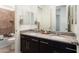 This bright bathroom features a spacious double vanity with granite countertops and a tiled shower at 23800 N 169Th Ave, Surprise, AZ 85387