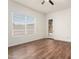 Bedroom with wood-look flooring, a window, and a ceiling fan at 23800 N 169Th Ave, Surprise, AZ 85387