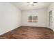 Bedroom with wood-look flooring, a window, and a ceiling fan at 23800 N 169Th Ave, Surprise, AZ 85387