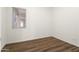 Bright bedroom with hardwood flooring, fresh paint, a window that provides natural light, and electrical outlets at 23800 N 169Th Ave, Surprise, AZ 85387