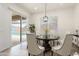 Cozy dining room with modern chandelier and large window overlooking the pool area at 23800 N 169Th Ave, Surprise, AZ 85387