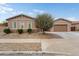 Charming single-story home featuring desert landscaping, a well-manicured lawn, and an attached two car garage at 23800 N 169Th Ave, Surprise, AZ 85387