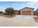 Charming home exterior featuring a well-maintained yard, mature landscaping, and a spacious three-car garage at 23800 N 169Th Ave, Surprise, AZ 85387