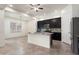 Spacious kitchen with stainless steel appliances, dark cabinets, and a center island perfect for meal prep and entertaining at 23800 N 169Th Ave, Surprise, AZ 85387