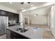 Large kitchen featuring sleek stainless steel appliances, a center island and an open layout to the living area at 23800 N 169Th Ave, Surprise, AZ 85387