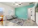 Bright living room with an accent wall, tile flooring, a ceiling fan, and armchairs with a rug at 23800 N 169Th Ave, Surprise, AZ 85387