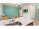 Open-concept living space with a bright kitchen area flowing into a comfortable seating area by a large window at 23800 N 169Th Ave, Surprise, AZ 85387