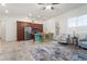 Open-concept living room and kitchen with tile flooring, stainless steel appliances, and cozy seating area at 23800 N 169Th Ave, Surprise, AZ 85387